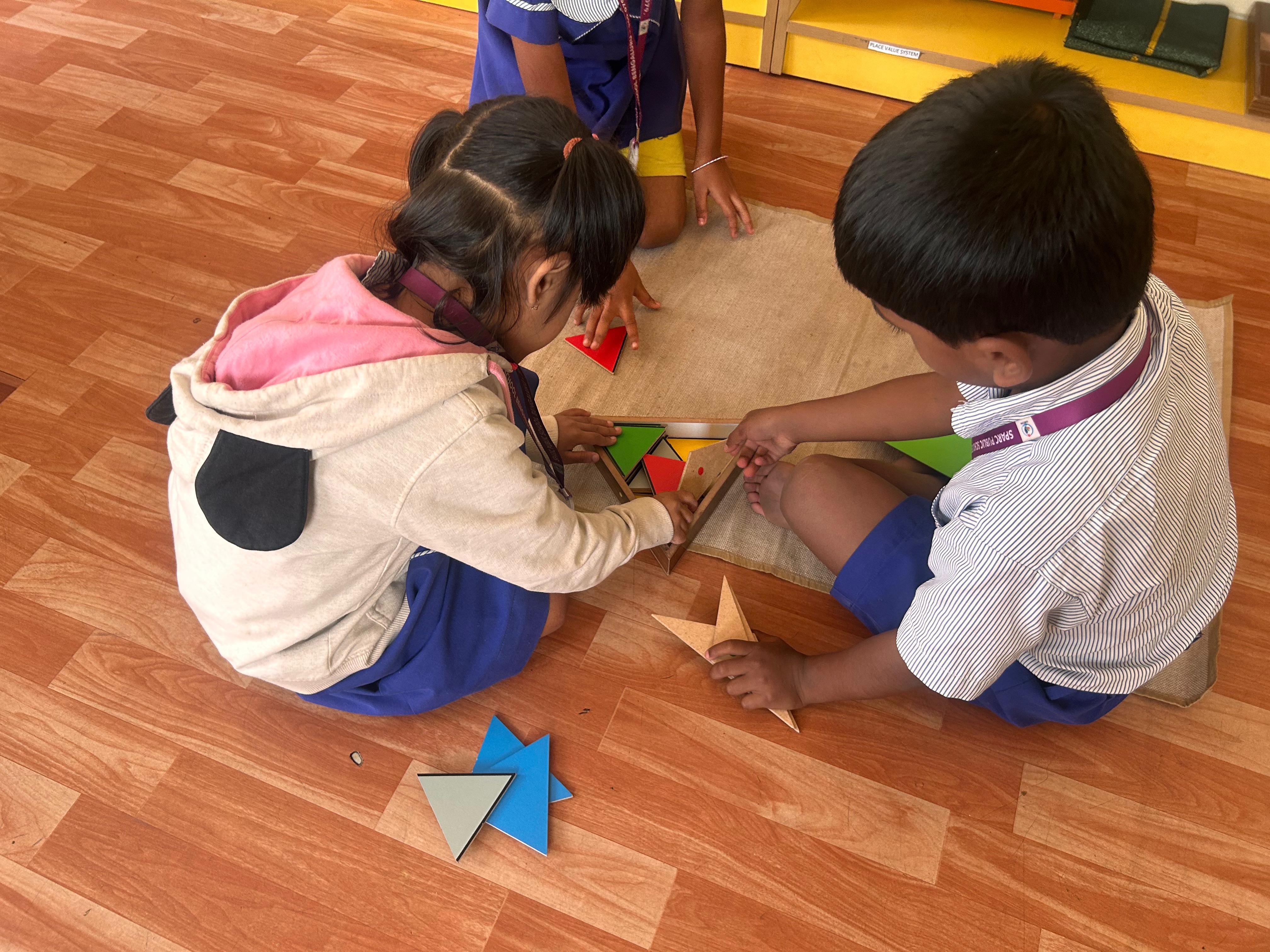 Students using hands-on materials during classroom floor work