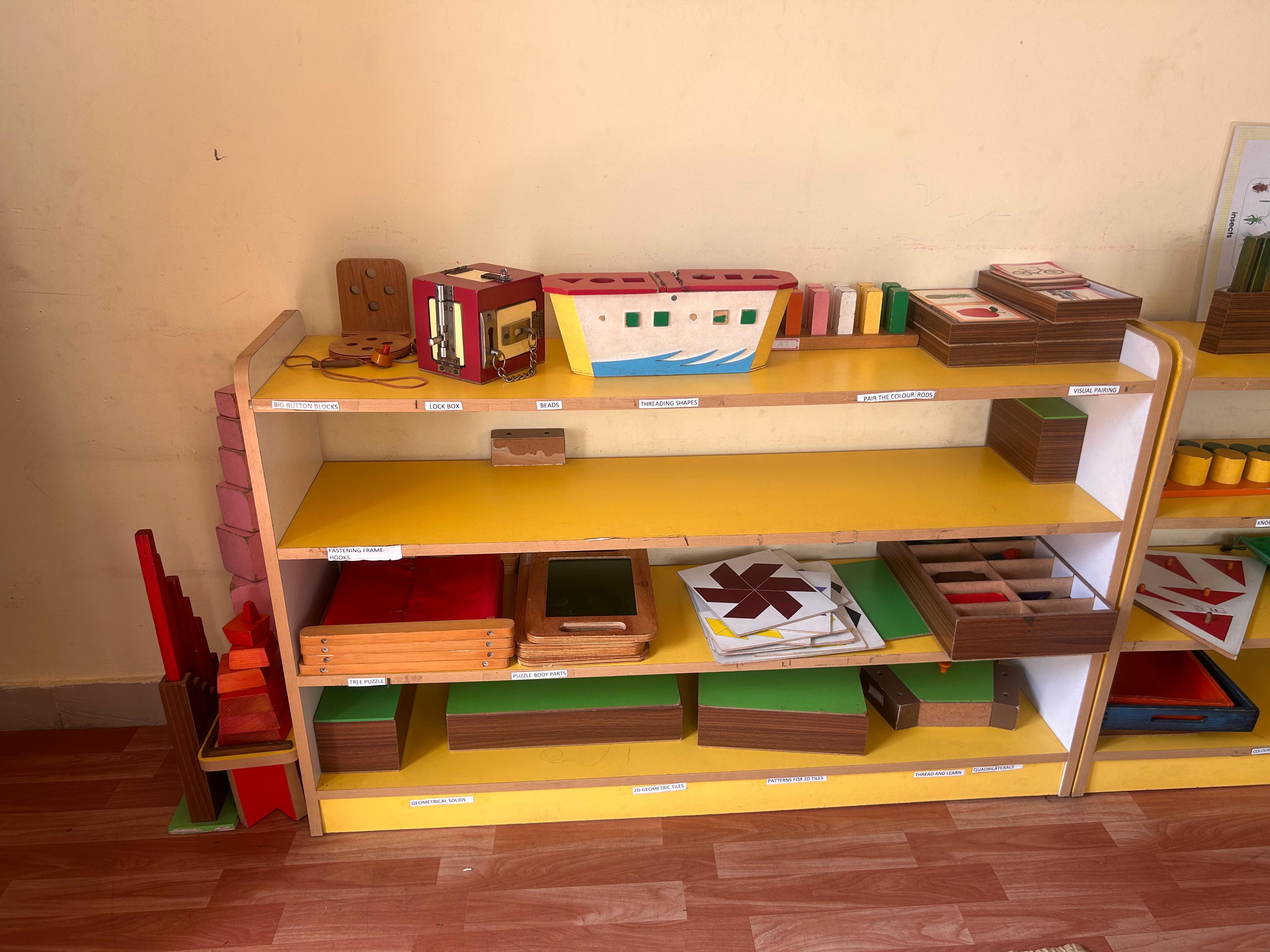 Montessori-style classroom shelf with learning materials