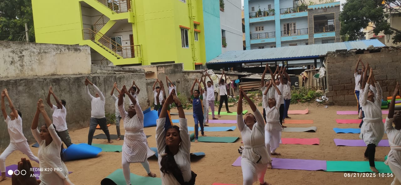 Students doing a standing yoga sequence with arms raised during morning wellness